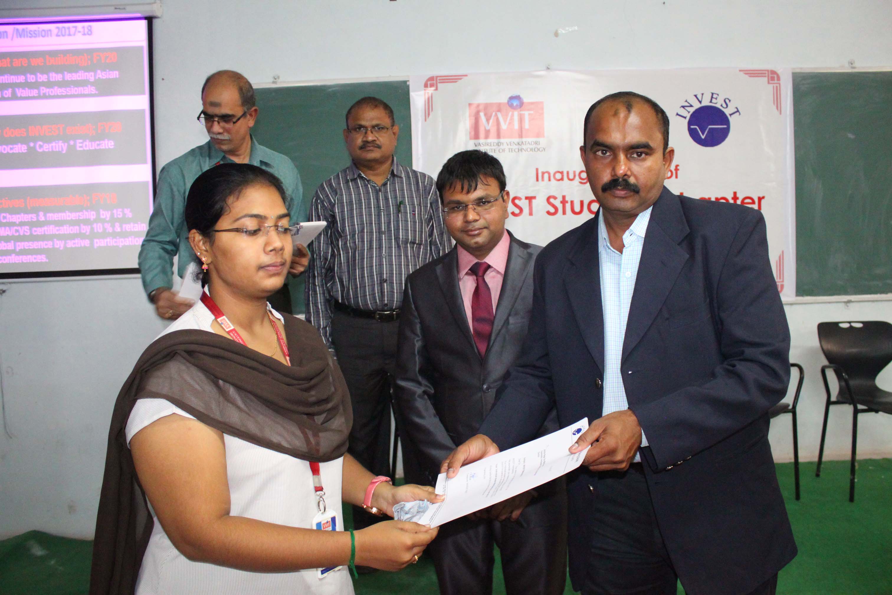 Daniel Arcodium giving away certificates to students